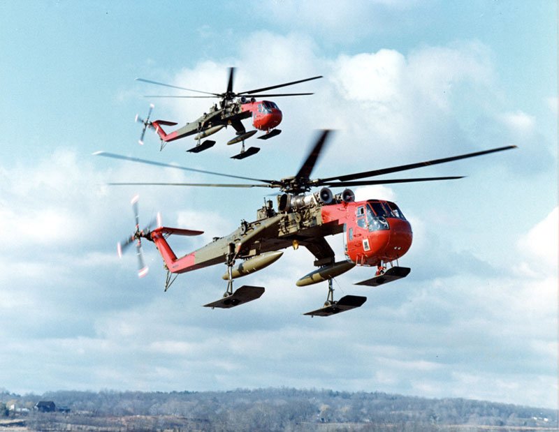 Photo of two unladen Sikorsky CH-54 helicopters in flight